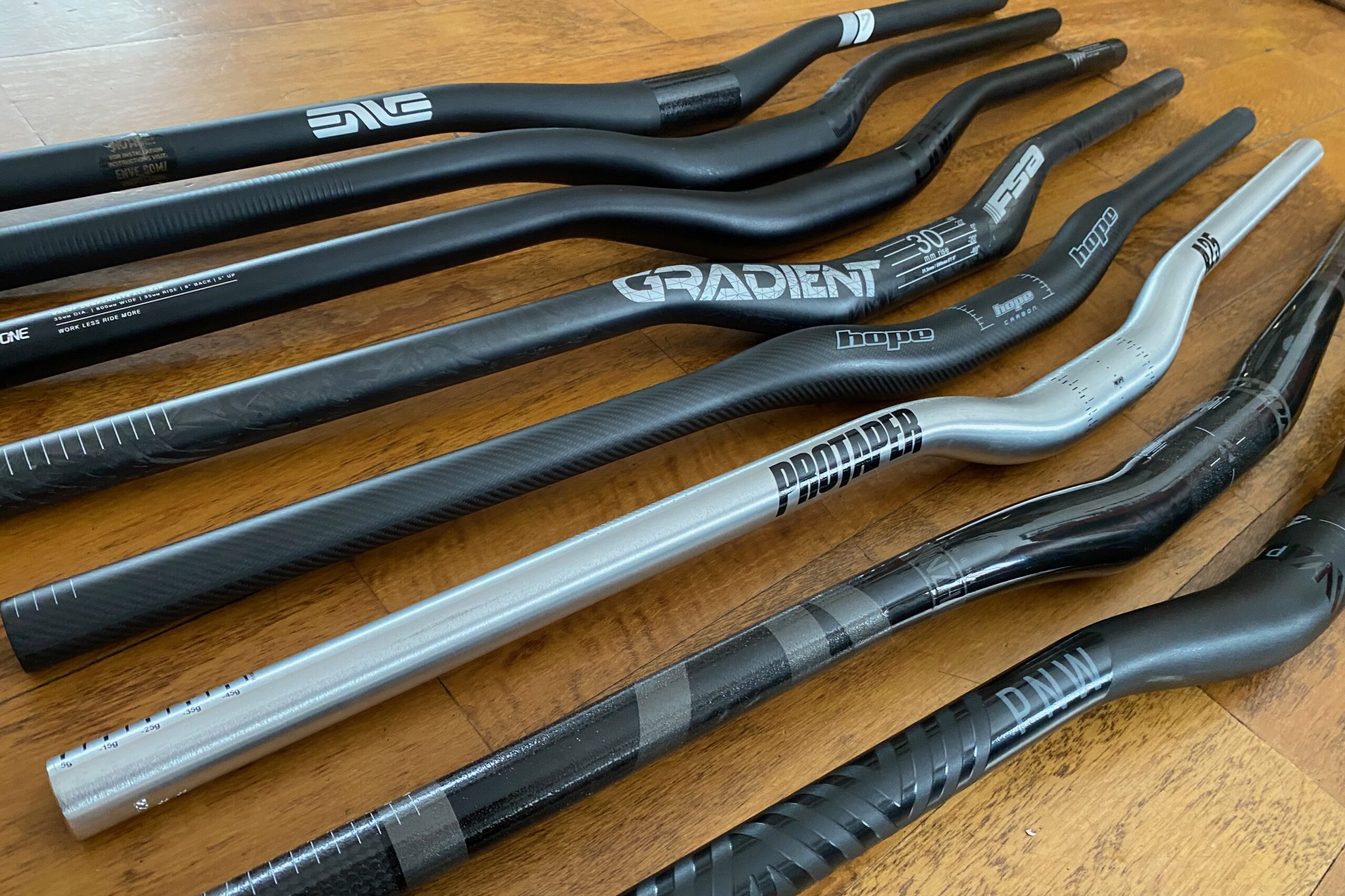 Group shot of eight mountain bike handlebars